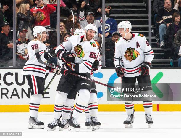 Jarred Tinordi of the Chicago Blackhawks celebrates his third-period goal against the Anaheim Ducks with Patrick Kane and Connor Murphy during the...