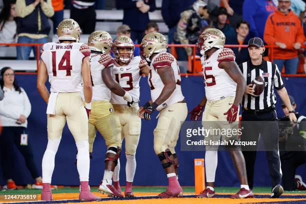 Jordan Travis of the Florida State Seminoles reacts with his teammates after scoring a touchdown against the Syracuse Orange during the game at JMA...