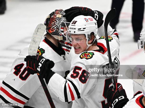 Chicago Blackhawks winger MacKenzie Entwistle celebrates on the ice with goalie Arvid Soderblom after the Blackhawks defeated the Anaheim Ducks 3 to...