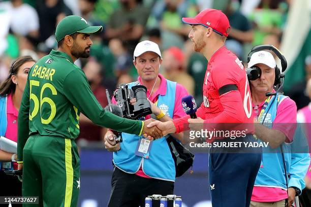 Pakistan's Captain Babar Azam shakes hands with England's Captain Jos Buttler at the toss during the ICC men's Twenty20 World Cup 2022 cricket final...