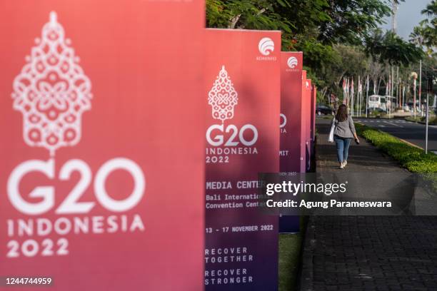 Woman walks near signage for G-20 Summit at The Nusa Dua ITDC on November 13, 2022 in Nusa Dua, Indonesia. The G20 leaders' meeting will take place...