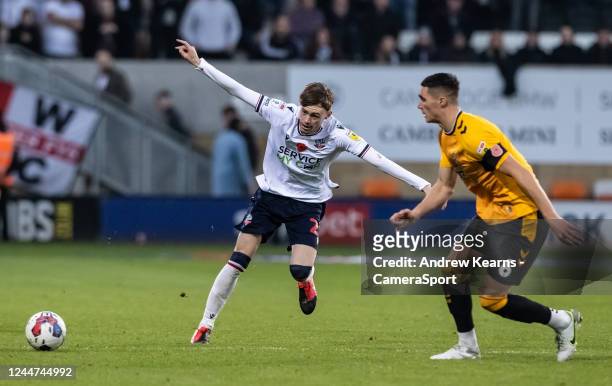 Bolton Wanderers' Conor Bradley passes under pressure from Cambridge United's Lloyd Jones during the Sky Bet League One between Cambridge United and...