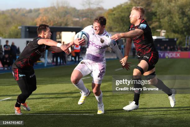 Fraser Dingwall of Northampton Saints runs in to score a try despite the efforts of Jackson Wray of Saracens and Ivan van Zyl of Saracens during the...