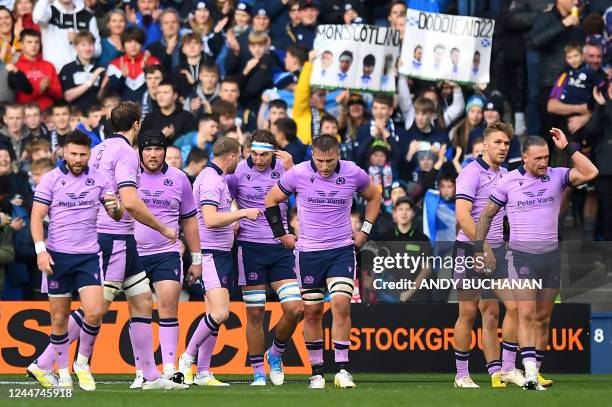 Scotland's wing Darcy Graham celebrates scoring a try with teammates during the Autumn Nations Series International rugby union match between...