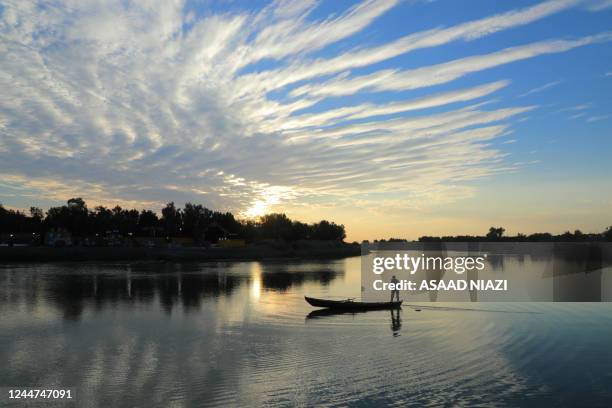 Fisherman casts his net into the Euphrates river in the Iraqi city of Nasiriyah in the Dhi Qar province, about 360 kms southeast of the capital, on...