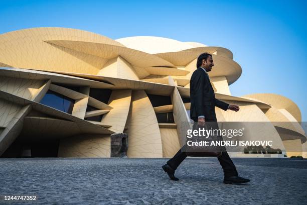 Man walks past the National Museum of Qatar building on November 13 ahead of the Qatar 2022 World Cup football tournament.