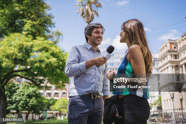 woman talking to a male new reporter live - tv journalists stock pictures, royalty-free photos & images