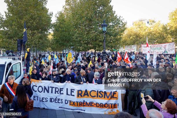 Protestors stand behind a banner during a demonstration against racism and far-right ideas called by French anti-racism association SOS Racisme and...