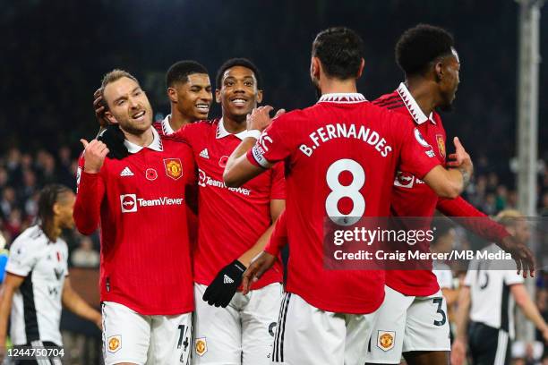 Christian Eriksen of Manchester United celebrates with team mates after scoring the opening goal during the Premier League match between Fulham FC...
