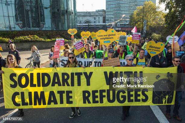 Supporters of Christian charity Tearfund join climate justice campaigners marching from the Shell Centre to Trafalgar Square to demand urgent climate...