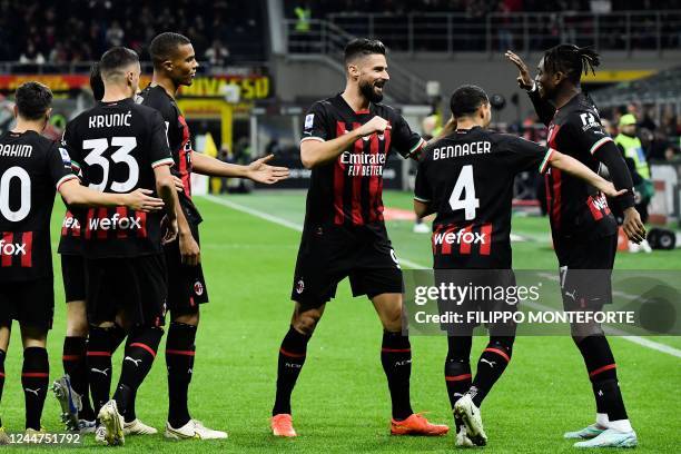 Milan's Portuguese forward Rafael Leao celebrates with AC Milan's French forward Olivier Giroud and teammates after opening the scoring during the...