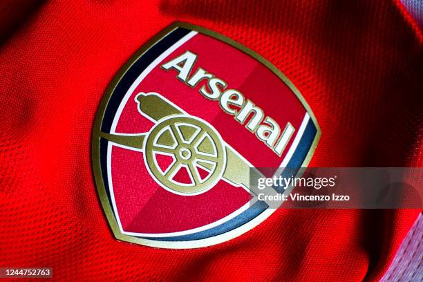 In this photo illustration a English Arsenal team logo sewn on a red jersey. Famous team of the British league founded by David Danskin, it is one of...