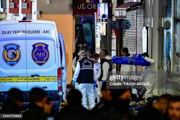 Members the crime scene investigation police work after a strong explosion of unknown origin shook the busy shopping street of Istiklal in Istanbul,...