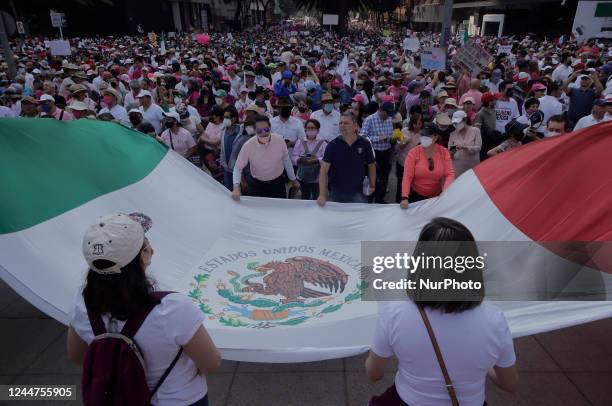 Group of people waves a Mexican flag on the esplanade of the Monument to the Revolution in Mexico City, where various organizations, businessmen and...