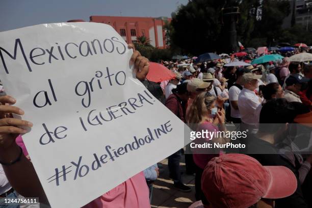 Person carries a banner on the esplanade of the Monument to the Revolution in Mexico City, as a sign of rejection of the electoral reform presented...