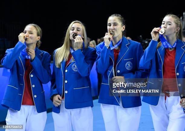 Switzerland's Viktorija Golubic, Switzerland's Jil Teichmann, Switzerland's Belinda Bencic and Switzerland's Simona Waltert pose with their medals...