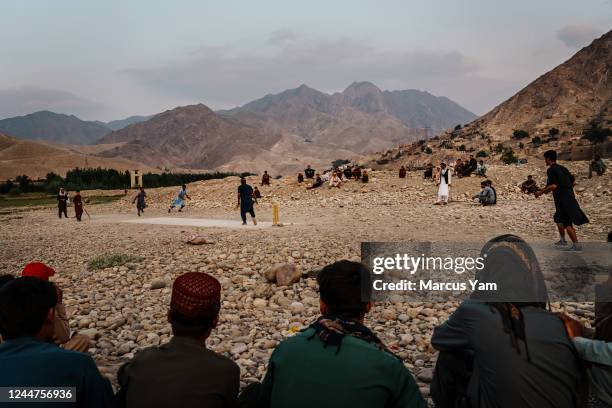 Men play cricket as the evening sun sets at the Surobi reservoir on the road to Kabul, from Jalalabad, Afghanistan, Sunday, Sept. 11, 2022.