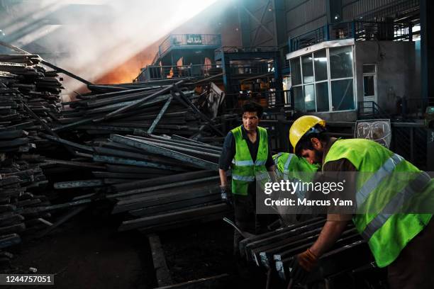 Workers labor over various stages of steel in its production line at a steel plant that Yu Minghui, 51-year-old entrepreneur from China, partially...