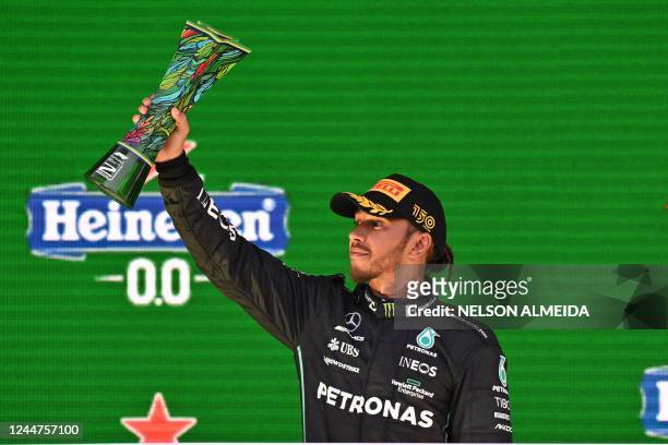 Second-placed Mercedes' British driver Lewis Hamilton celebrates on the podium after the Formula One Brazil Grand Prix, at the Autodromo Jose Carlos...