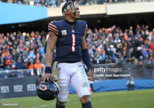 Chicago Bears quarterback Justin Fields looks on as he bleeds from his right ear after being sacked during a game between the Detroit Lions and the...