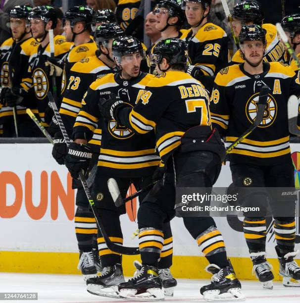 Brad Marchand of the Boston Bruins celebrates his goal against the Vancouver Canucks during the second period with teammate Jake DeBrusk at the TD...
