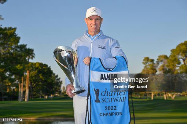 Steven Alker of New Zealand holds the Charles Schwab Cup on the 18th green after the final round of the PGA TOUR Champions Charles Schwab Cup...