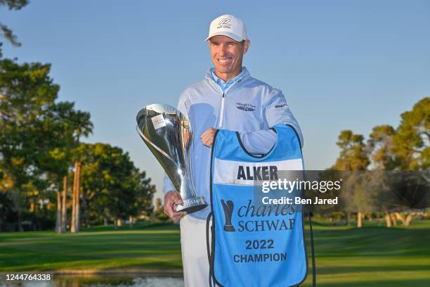 Steven Alker of New Zealand holds the Charles Schwab Cup on the 18th green after the final round of the PGA TOUR Champions Charles Schwab Cup...