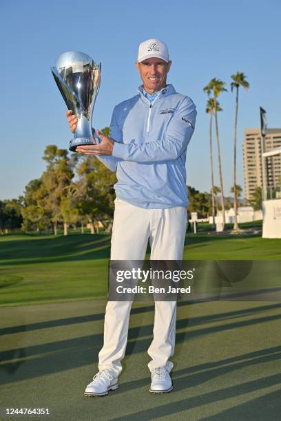 Steven Alker of New Zealand holds the Charles Schwab Cup on the 18th green after the final round of the PGA TOUR Champions Charles Schwab Cup...