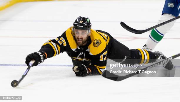 Nick Foligno of the Boston Bruins dives for the puck against the Vancouver Canucks at the TD Garden on November 13, 2022 in Boston, Massachusetts....