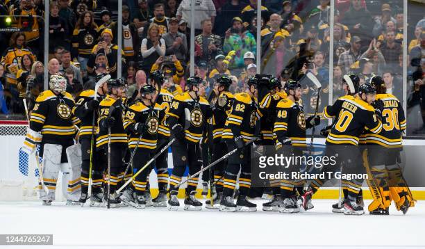 The Boston Bruins celebrate a 5-2 victory against the Vancouver Canucks at the TD Garden on November 13, 2022 in Boston, Massachusetts.