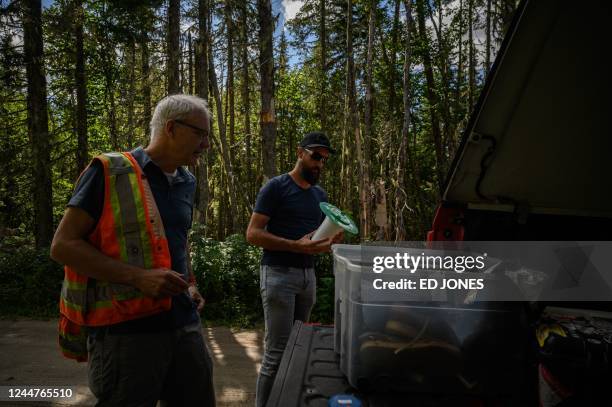 Canadian forest service research scientist David Paré and research scientist Yan Boulanger gather equipment before checking an area of forest...