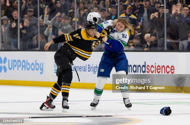 Greer of the Boston Bruins fights Vasily Podkolzin of the Vancouver Canucks during the first period at the TD Garden on November 13, 2022 in Boston,...