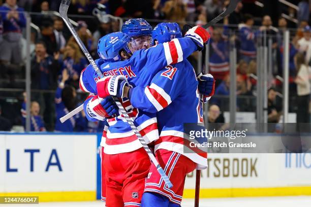 Barclay Goodrow of the New York Rangers celebrates with teammates Jimmy Vesey and Vincent Trocheck after scoring during the second period of the game...