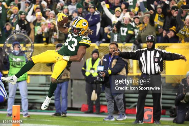 Green Bay Packers running back Aaron Jones leaps into the end zone during a game between the Green Bay Packers and the Dallas Cowboys at Lambeau...