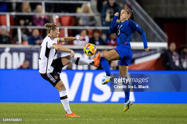 Alexandra Popp of Germany and Alex Morgan of United States jump for the control of the ball in the first half of the women's international friendly...