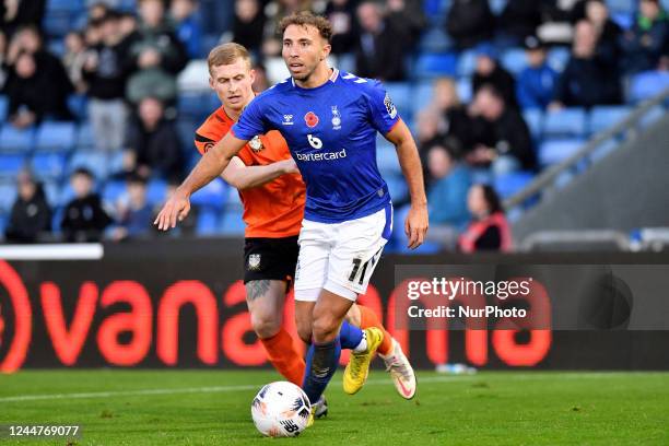 Hallam Hope of Oldham Athletic tussles with Sam Beard of Barnet Football Club during the Vanarama National League match between Oldham Athletic and...