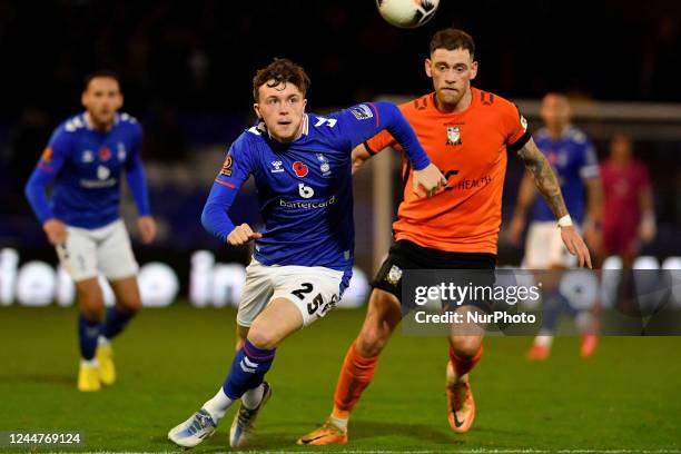 Conor Carty of Oldham Athletic tussles with Harry Pritchard of Barnet Football Club during the Vanarama National League match between Oldham Athletic...
