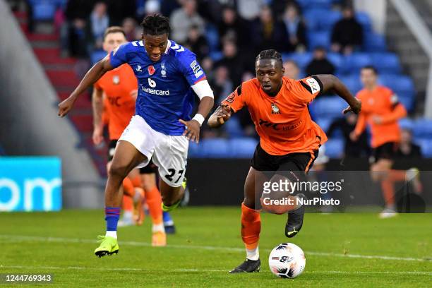 Timmy Abraham of Oldham Athletic tussles with Idris Kanu of Barnet Football Club during the Vanarama National League match between Oldham Athletic...