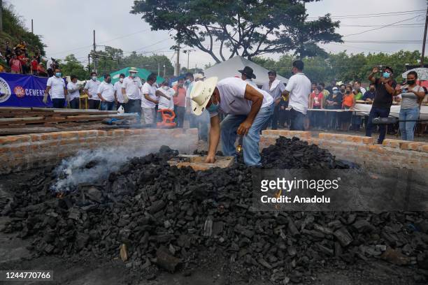 Salvadoran lights a charcoal fire in the elaboration of the most gigantic pupusa in the world, during the 18th Festival of the Pupusa in the...
