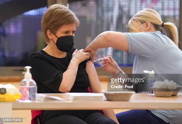 First Minister of Scotland Nicola Sturgeon receives a Covid booster jab and a separate flu jab from healthcare support worker vaccinator Helen...