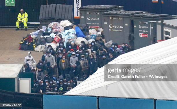 Group of people thought to be migrants wait to be processed after being brought in to Dover, Kent, onboard a Border Force vessel, following a small...
