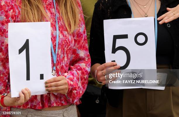 Climate activists gather with signs for a demonstration calling upon the G20 conference to adhere to limit global temperature rise to 1.5 degrees...