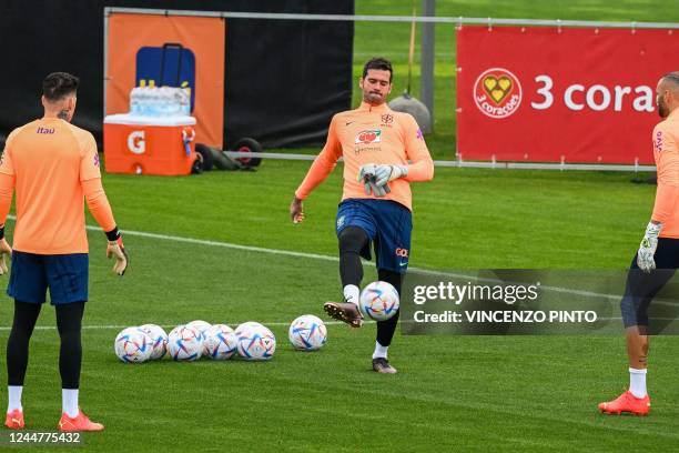 Brazil's goalkeeper Ederson, Brazil's goalkeeper Alisson and Brazil's goalkeeper Weverton attend a training session on November 14, 2022 at the...