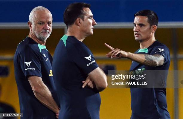 Former Australian footballer Tim Cahill gestures near Australia's coach Graham Arnold during a training session at the Aspire Academy in Doha on...