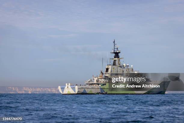 Severn, a patrol vessel of the Royal Navy and part of the Coastal Forces Squadron collecting a small inflatable vessel used by Asylum Seekers while...