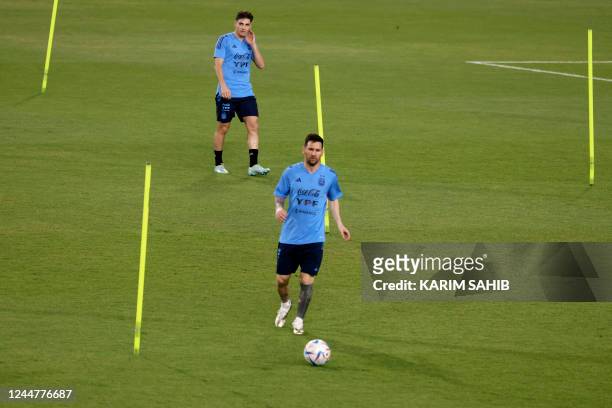 Argentine forward Lionel Messi kicks the ball on the pitch as the national Argentine football team attend a training camp in Abu Dhabi ahead of the...