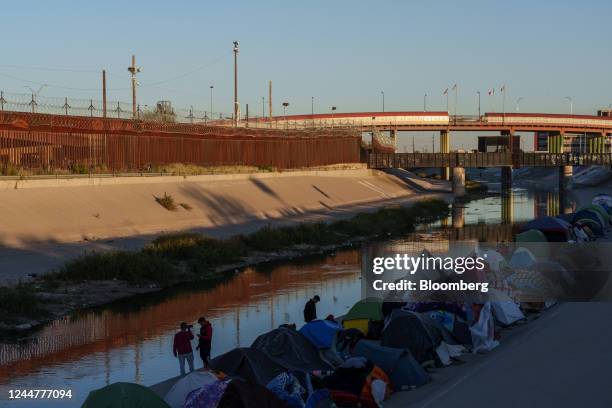 Makeshift migrant encampment near the Rio Grande in Ciudad Juarez, Mexico, on Sunday, Nov. 13, 2022. Poverty in Venezuela fell for the first time in...