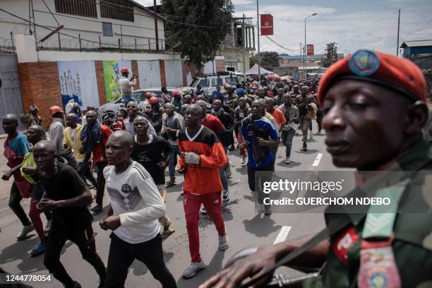 Hundreds of volunteers march to the airport to be directed to a training center after responding to Democratic Republic of Congo's President Felix...