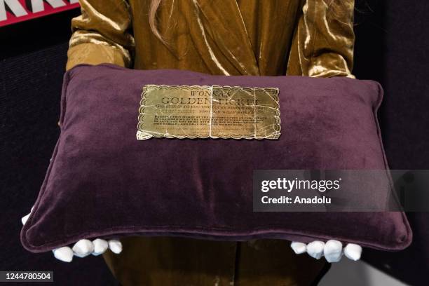 Staff member presents an original production-made Golden Ticket for Willy Wonka & The Chocolate Factory, Paramount estimate: Â£8,000 - 12,000 during...