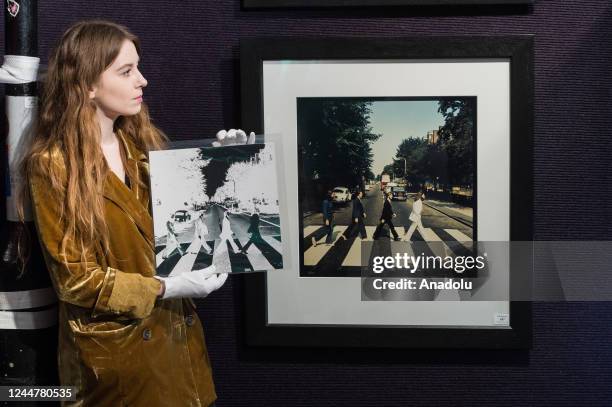 Staff member holds a negative image from The Beatles: a series of alternative mock-ups tor The 'Abbey Road' album cover estimate: Â£800 - Â£1,200...